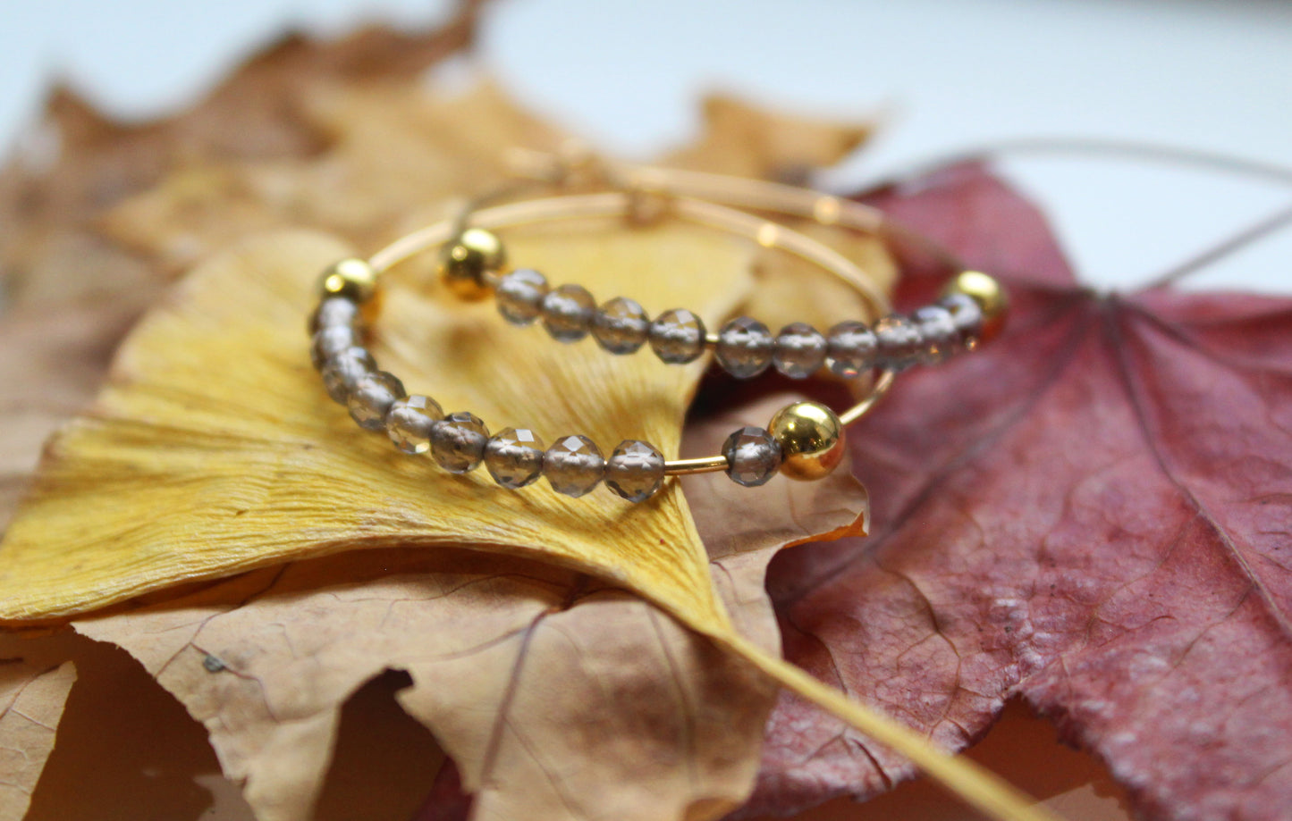 Smoky quartz gold hoop earrings with warm natural tones
