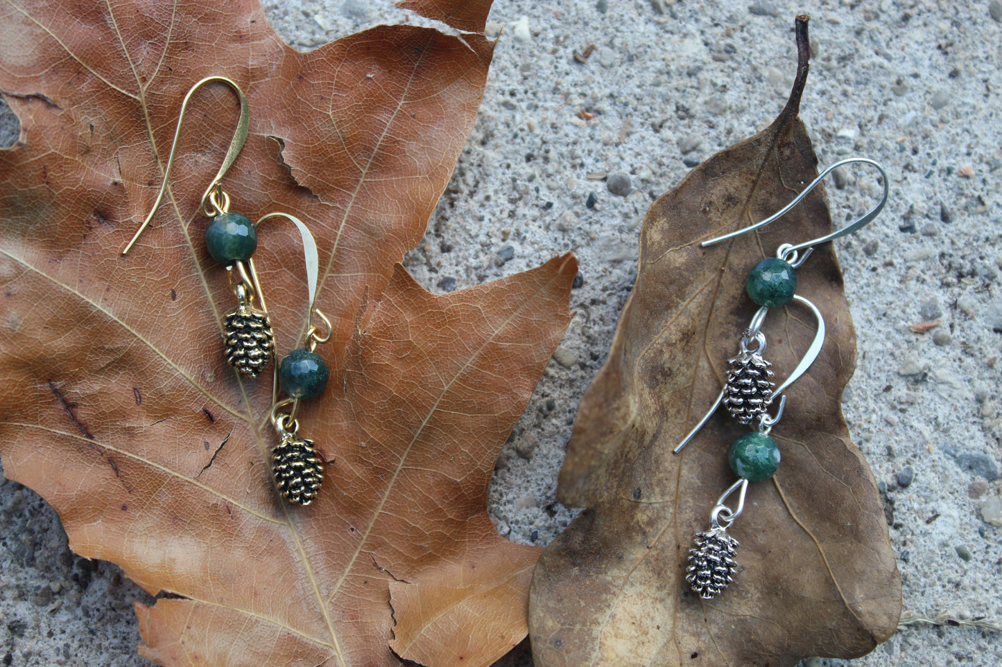 Moss agate gold pine cone drop earrings styled on wood