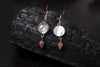 Sunstone and mother of pearl gold drop earrings by Luminous Moon
