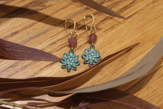 Teal flower with pink faceted gemstone