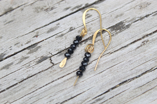 Black spinel gemstone gold drop earrings by Luminous Moon