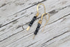 Black spinel gemstone gold drop earrings by Luminous Moon