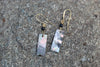 Black spinel and shell gold drop earrings by Luminous Moon